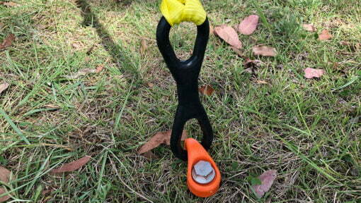 High vis strap attached to safety spring secured in the ground with a ground dog screw in pegs and hook collar