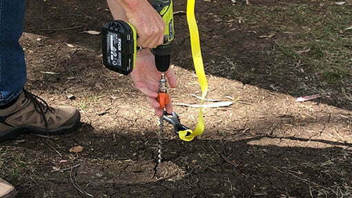 Drilling ground dog screw in peg in ground using 19mm soekct and drill adaptor